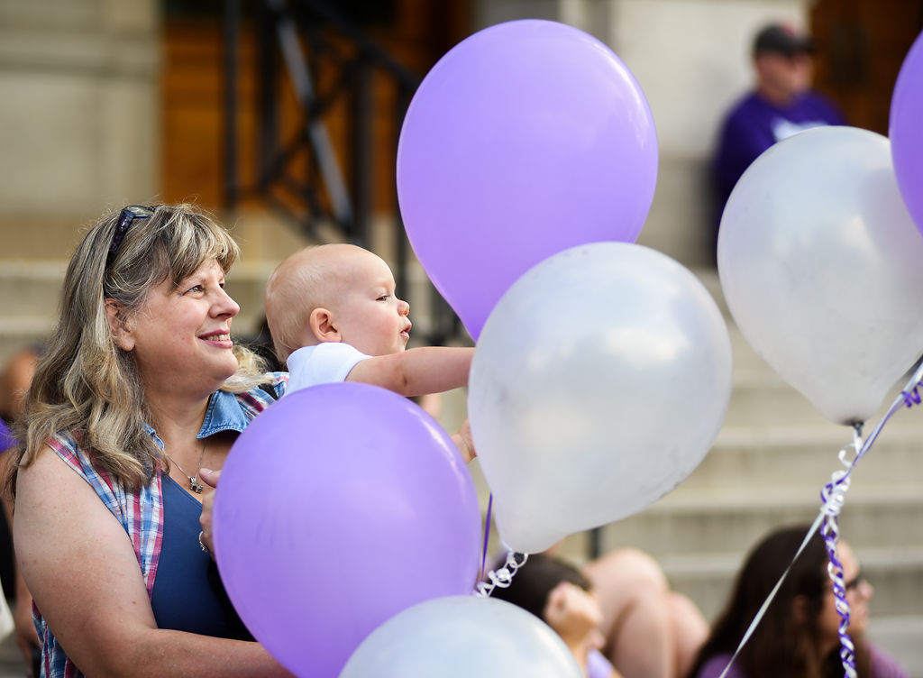 Pam Regan holds up her grandson